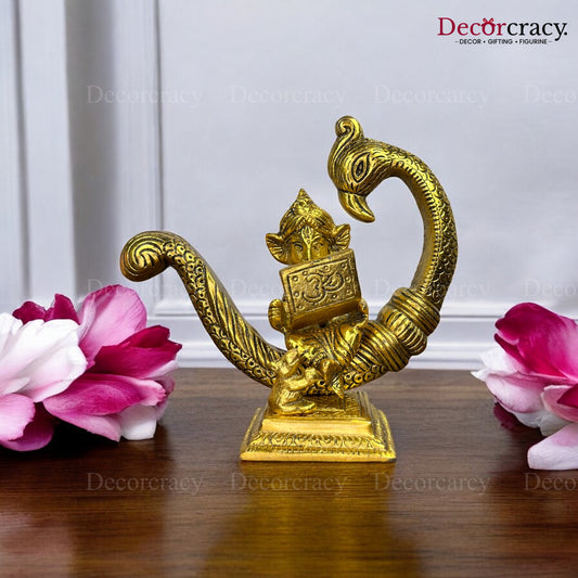 Ganesh sitting on Peacock & Reading Metal golden